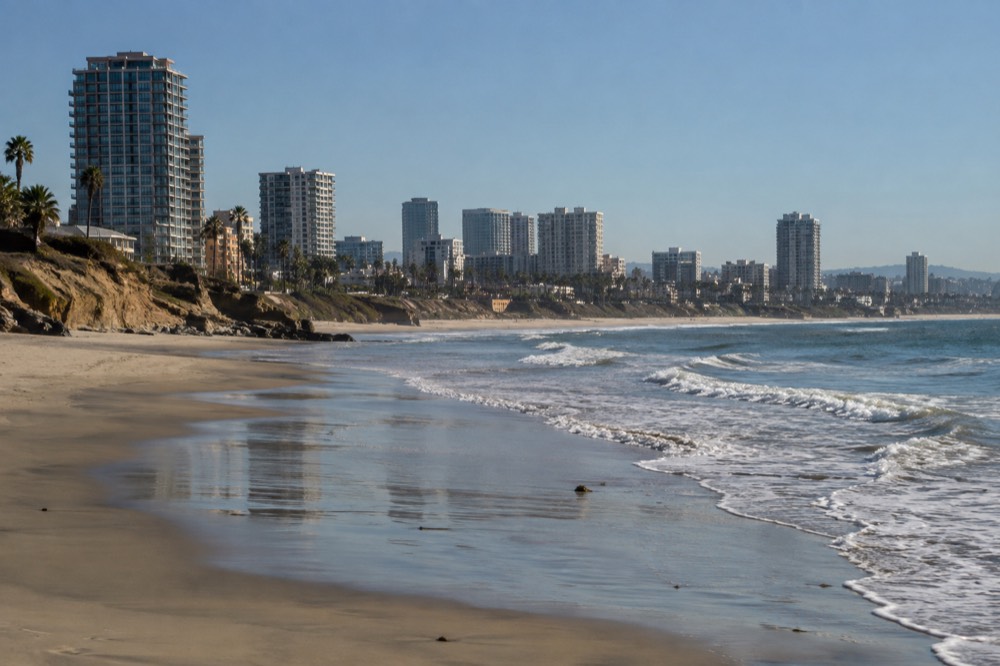 Empty San Diego beach with gentle waves under a clear morning sky