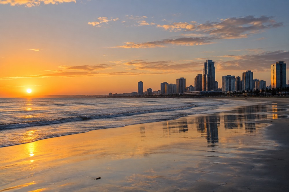 An empty San Diego beach at golden hour with calm water and no crowds