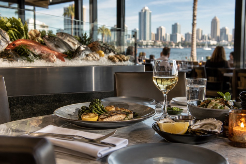 Dining table set for dinner in an upscale seafood restaurant with the day's catch on ice in the background