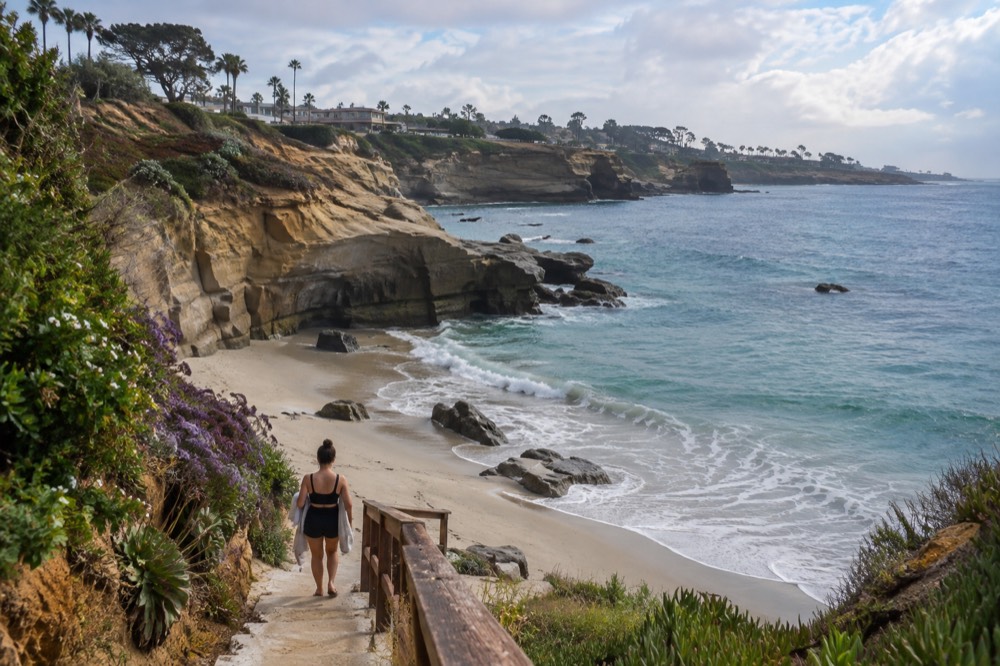 Turquoise water and sandstone cliffs at a small cove beach in La Jolla
