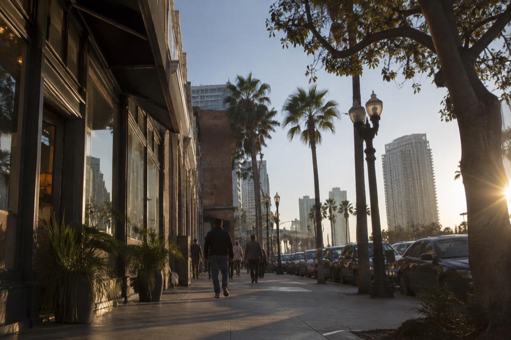 Historic storefronts and sidewalk shoppers in a downtown San Diego district