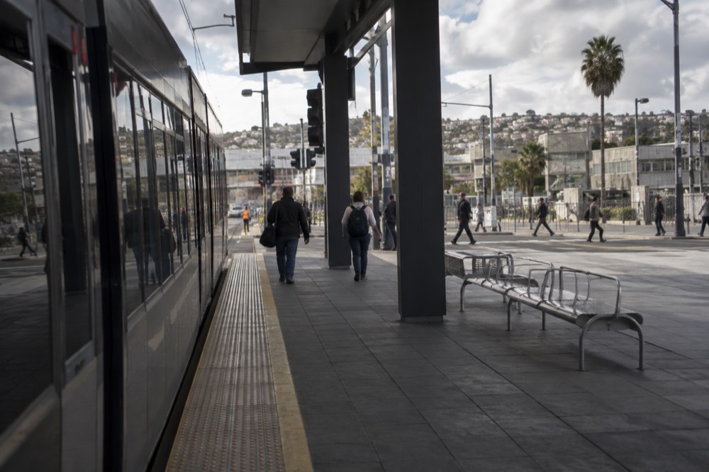 Trolley platform at the San Ysidro border transit center with the pedestrian crossing beyond