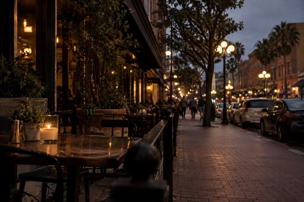 Gaslamp street at night with illuminated lamps and lit restaurant windows