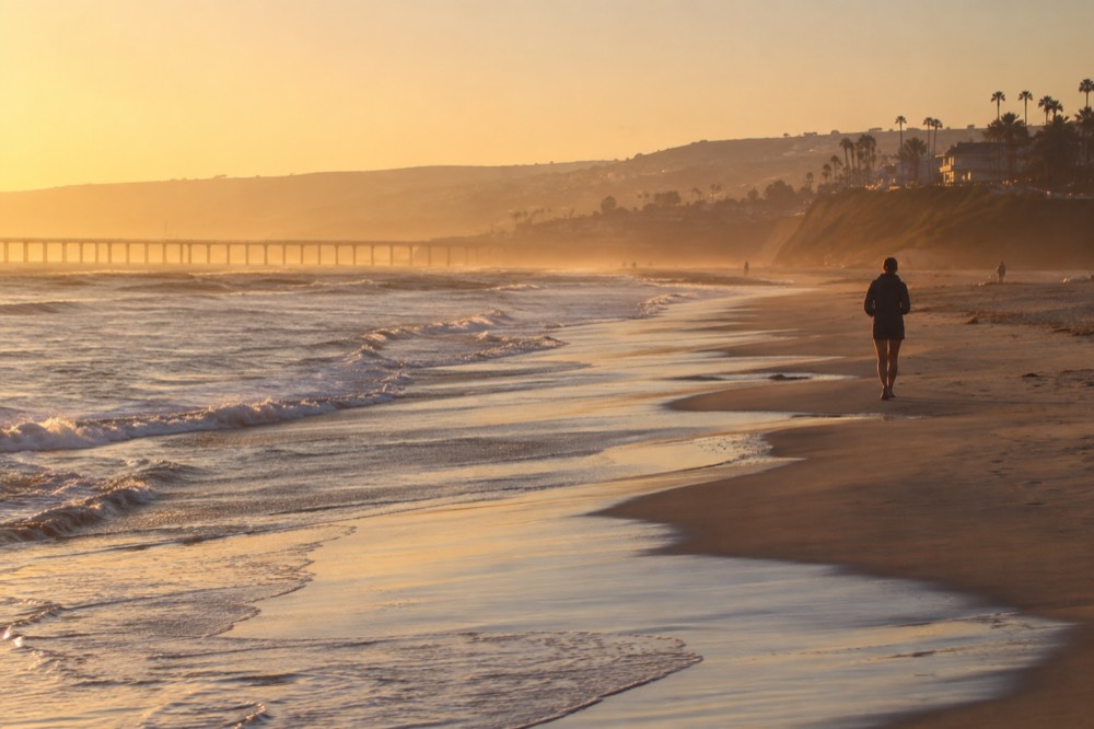 Gentle waves breaking on an empty wide beach in early morning light