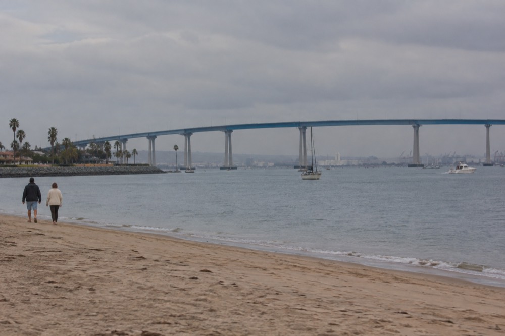 The San Diego-Coronado Bay Bridge curving high over the blue water of the bay