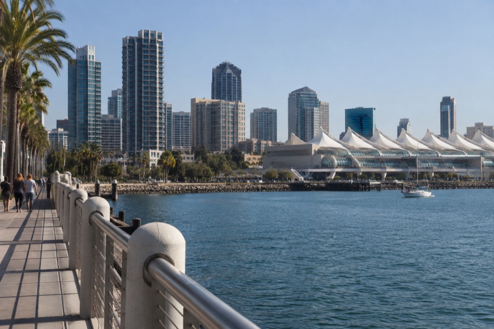 White sail-shaped roof of a large waterfront convention hall on a clear day