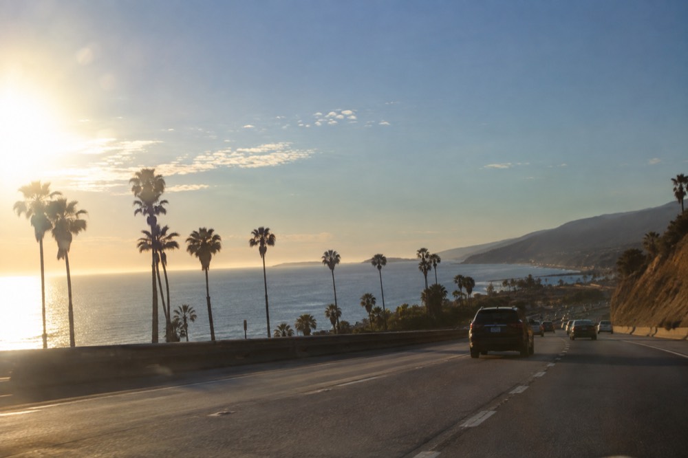 Freeway lanes heading south along the California coast with light traffic