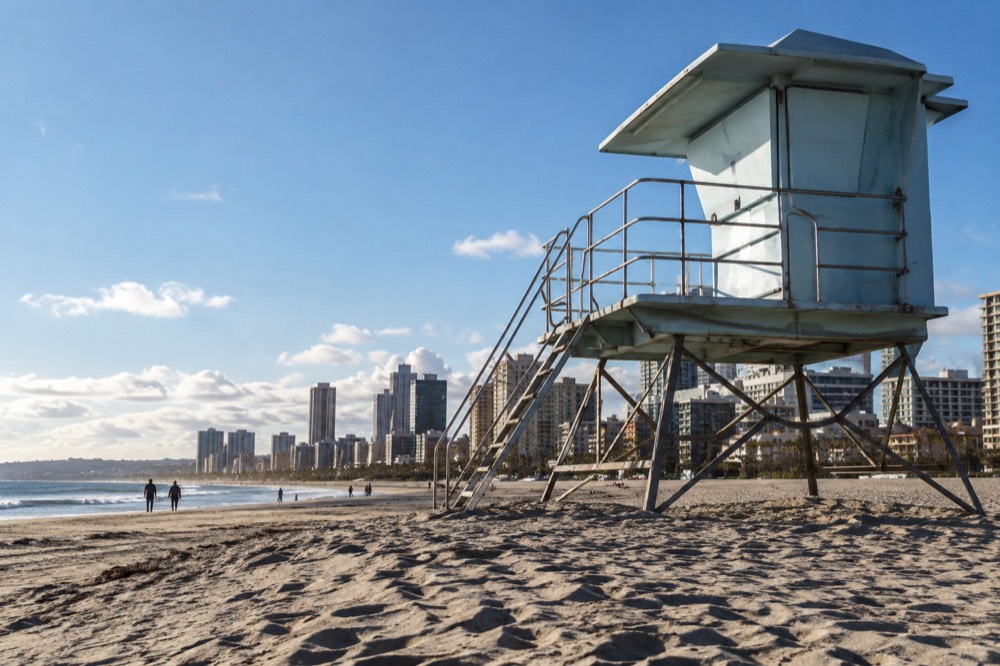 Lifeguard tower on a wide beach with gentle surf in the morning