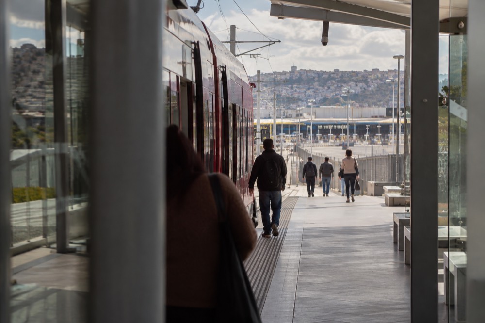A trolley platform at the southern end of the line with a border crossing structure in the distance