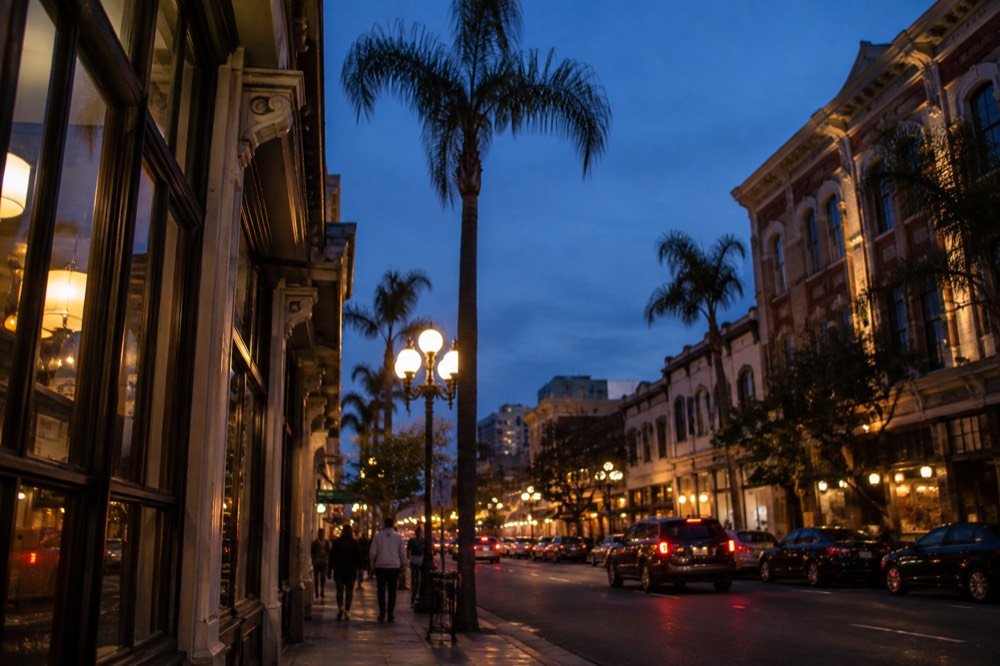 Gaslamp Quarter street at night with lit restaurant signs and palm trees