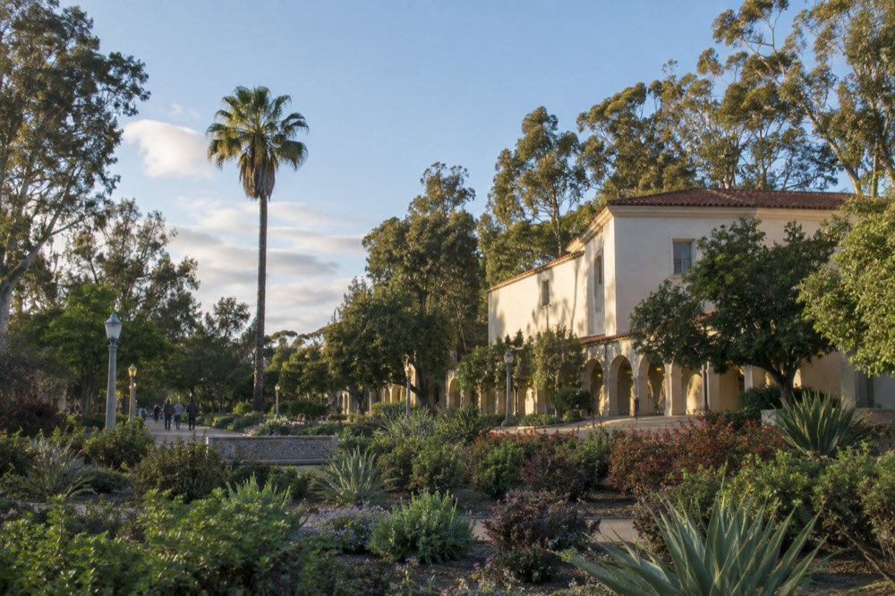 Illuminated museum buildings and gardens in Balboa Park on a December evening
