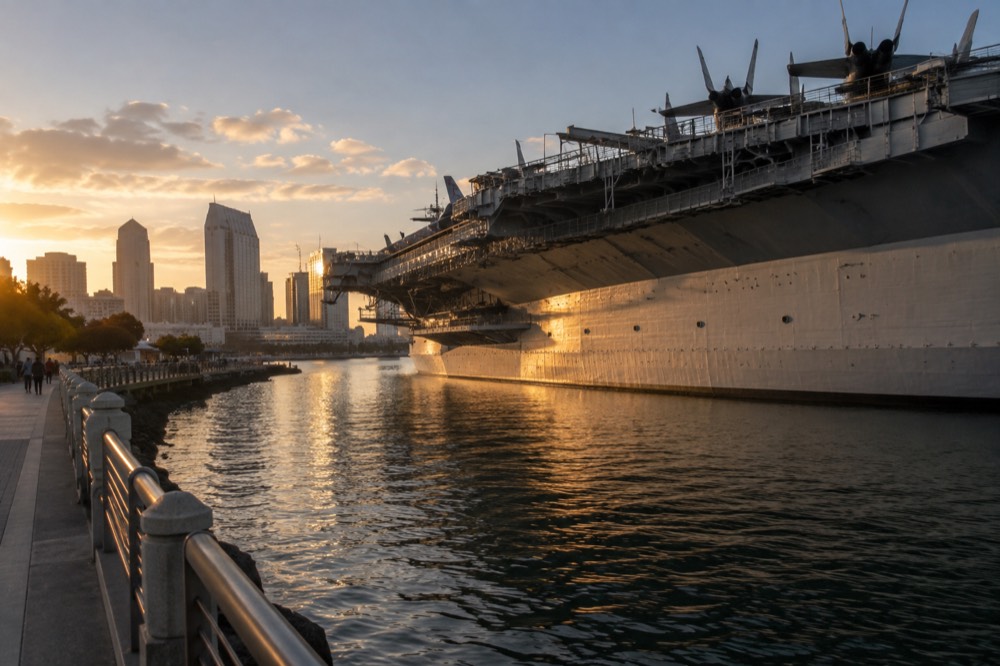 A historic aircraft carrier flight deck with the city skyline behind it