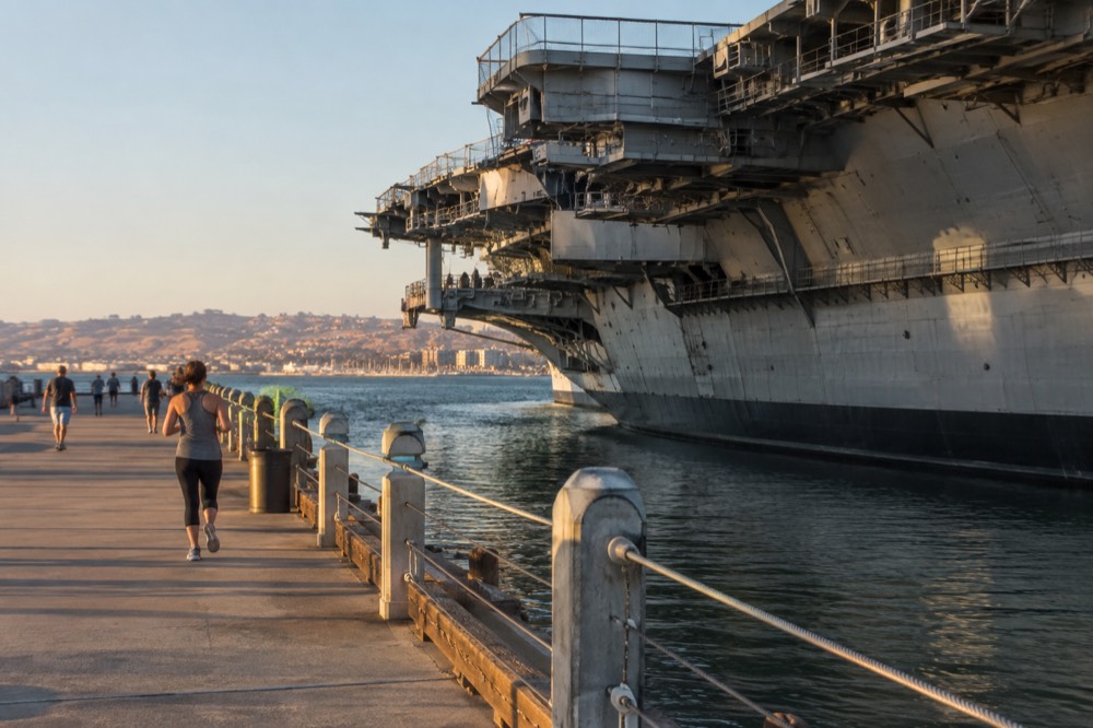 Historic aircraft carrier moored at a downtown waterfront dock