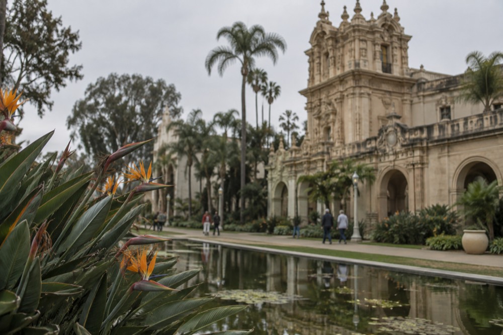 Historic ornate building facade and gardens in a large urban cultural park