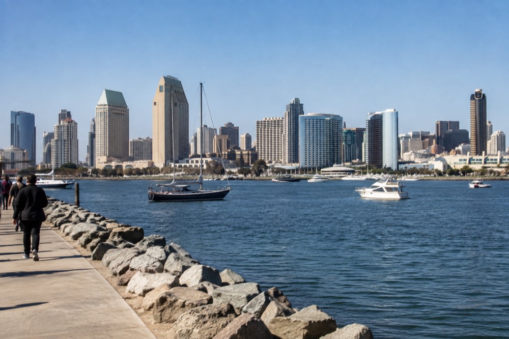 San Diego skyline and harbor bay water with boats at midday